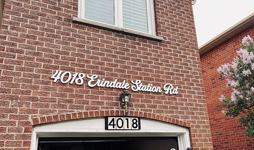 4018 Erindale Station Rd in white script on red brick
