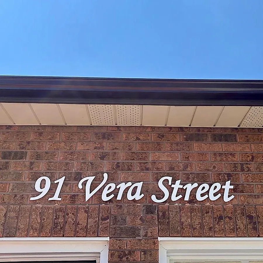 91 Vera Street in white script on brown brick