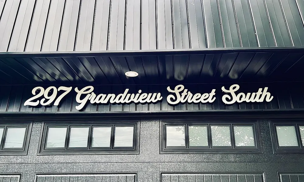 297 Grandview Street South in white script on dark siding