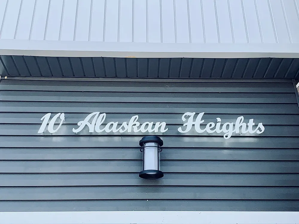 10 Alaskan Heights lit beside a wall lantern