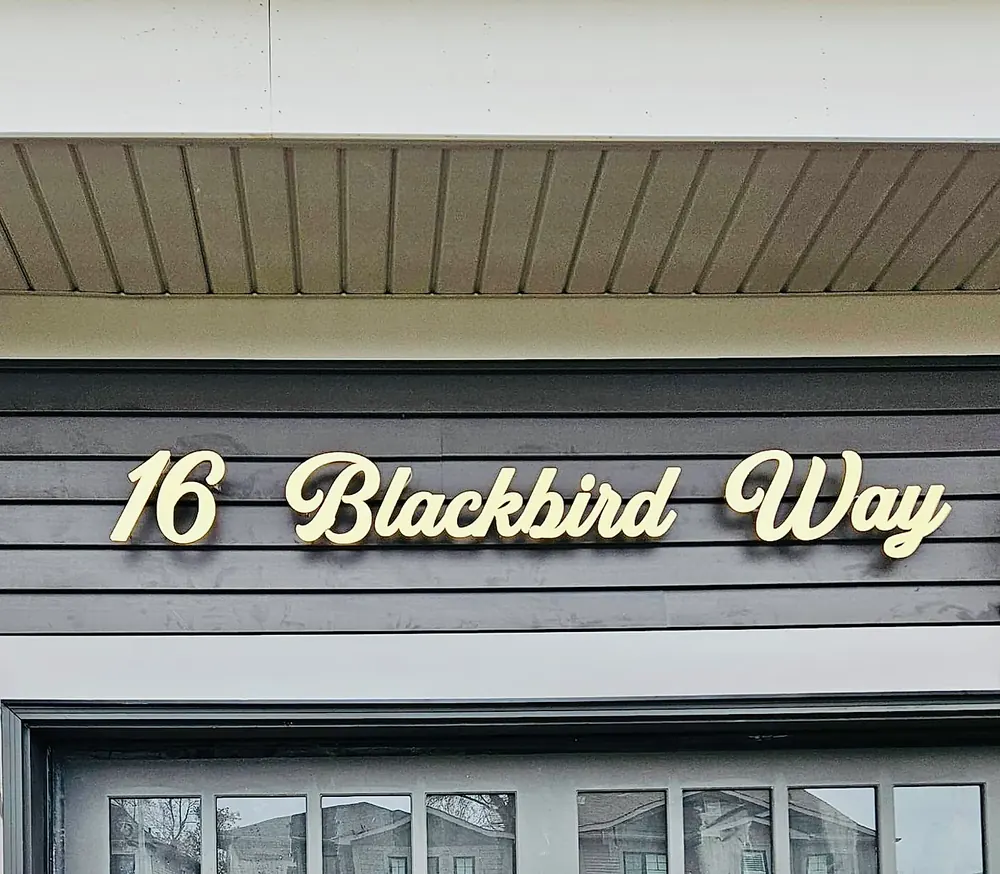 16 Blackbird Way in gold letters raised on stainless standoffs