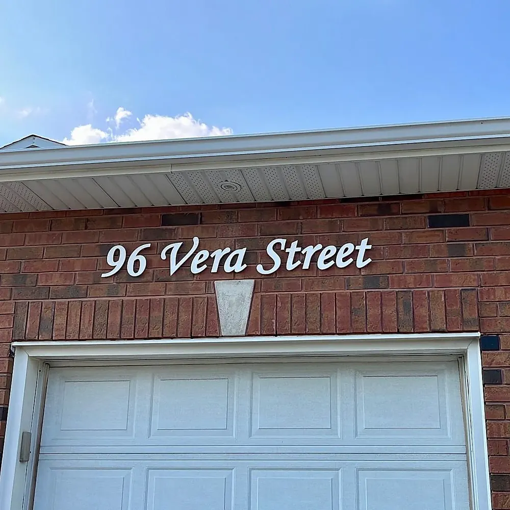 96 Vera Street in white script on red brick