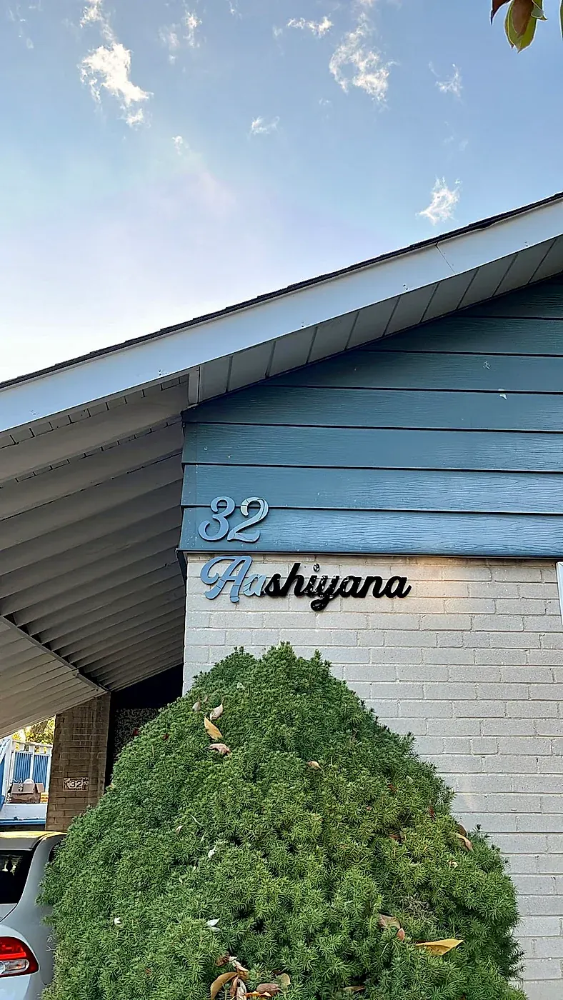 32 Aashiyana in white script on blue siding